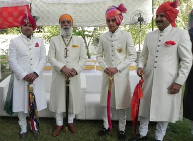 Men wearing cream sherwanis